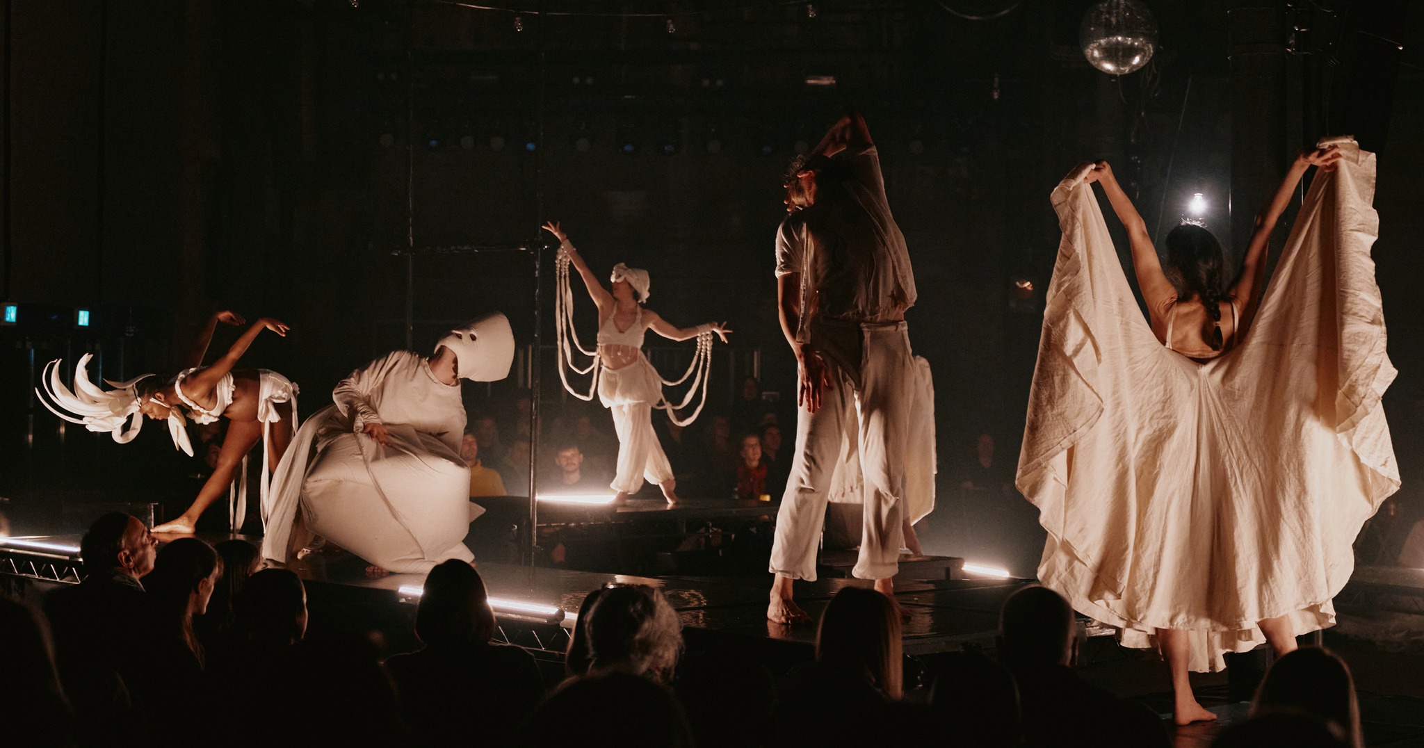 Mid-performance shot of multiple people on a stage