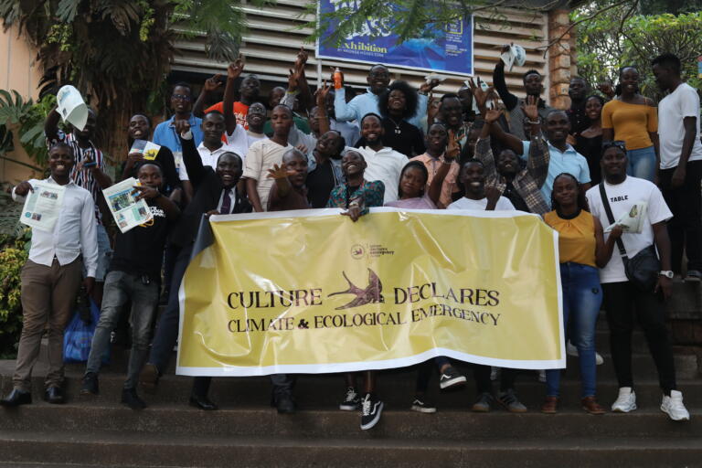 A group of people hold a Culture Declares banner at the CDE Uganda hub launch
